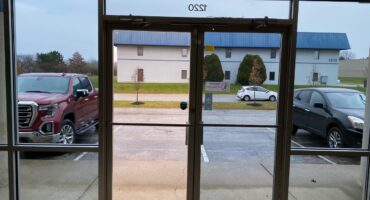 Cropped picture of before/ after solar window tint on glass door way