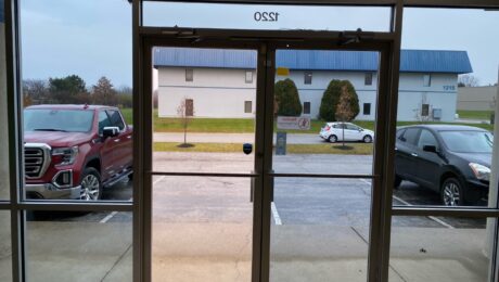 Cropped picture of before/ after solar window tint on glass door way